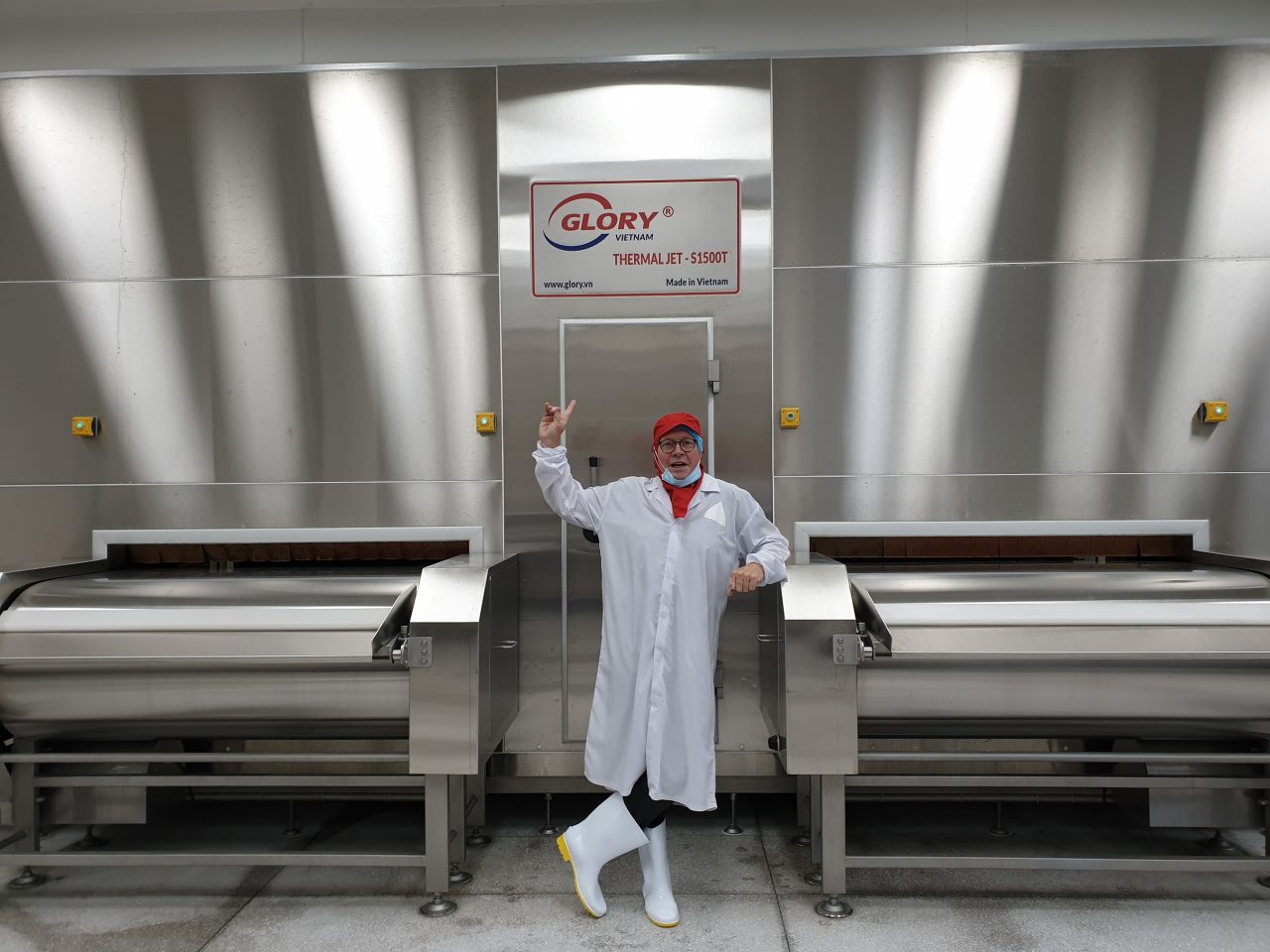 Engineer operating the GLORY Master AutoCell control panel